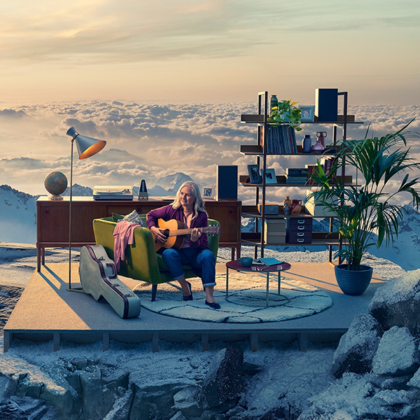 Image of woman on mountain top playing guitar